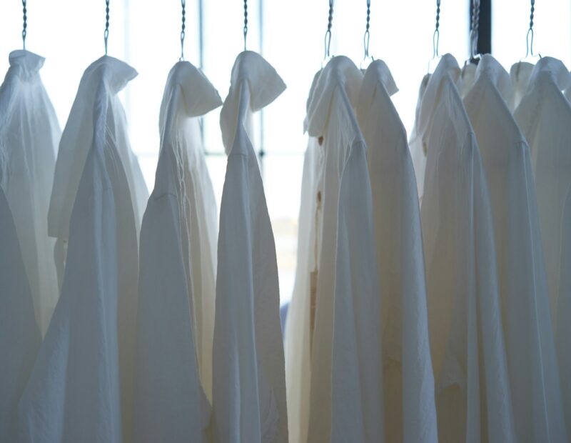 white dress shirt hangign on clothes